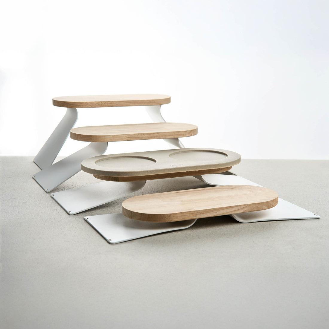 PINO Raised Tray Extensions at different heights, one with a Tray on top