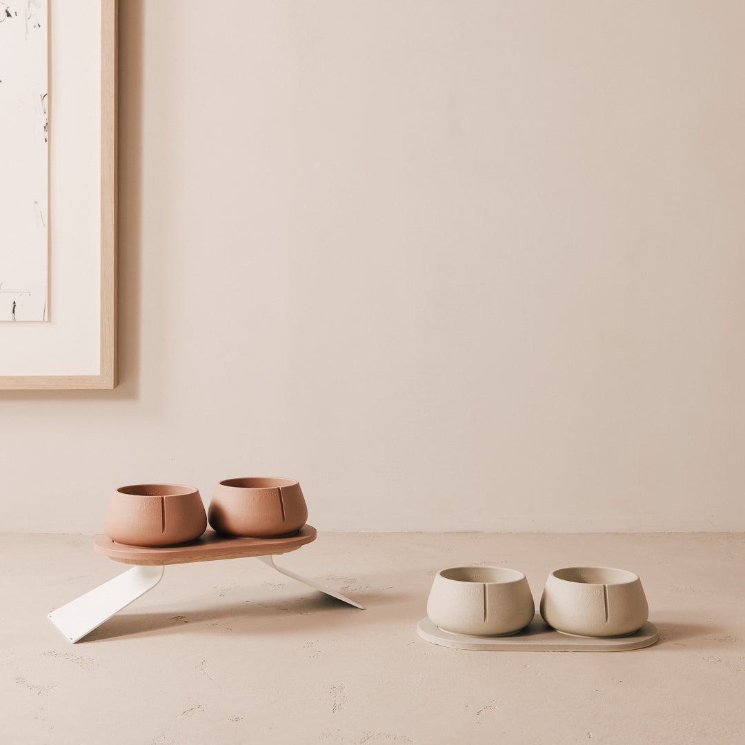 Terracotta bowls on a raised tray extension next to a sandstone set at floor level